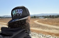 a man wearing a hat with the word ghetto on it