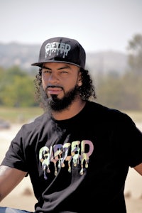 a black t - shirt with a man wearing a hat
